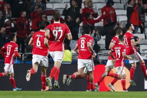 Benfica players celebrate after teammate Pizzi, right, scored their side's second goal during the Champions League group G soccer match between Benfica and Zenit St. Petersburg at the Luz stadium in Lisbon, Tuesday, Dec. 10, 2019. (AP Photo/Armando Franca)