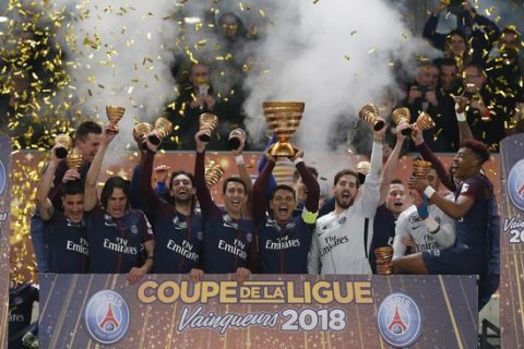 Paris Saint-Germain's team celebrate with their trophy after winning the League Cup final soccer match against Monaco in Bordeaux, southwestern France, Saturday, March 31, 2018. PSG won the match 3-0. (AP Photo/Thibault Camus)