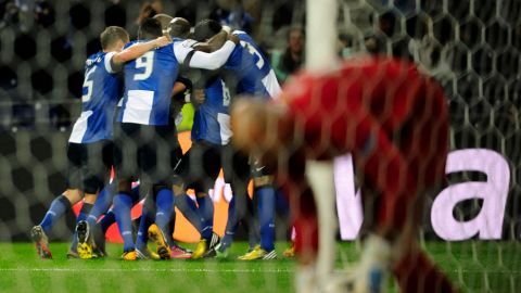 Porto's players celebrate their score during the UEFA Champions League round of 16 first leg football match FC Porto vs Malaga CF at the Dragao stadium in Porto on February 19, 2013. AFP PHOTO / FERNANDO VELUDO        (Photo credit should read FERNANDO VELUDO/AFP/Getty Images)