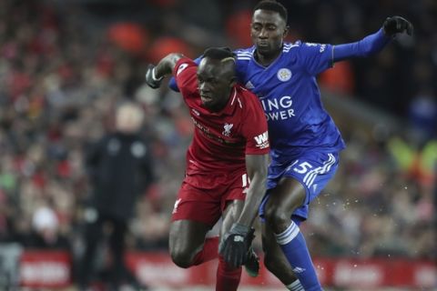 Liverpool forward Sadio Mane, left, is tackled by Leicester City midfielder Wilfred Ndidi during the English Premier League soccer match between Liverpool and Leicester City, at Anfield Stadium, Liverpool, England, Wednesday, Jan.29, 2019. (AP Photo/Jon Super)