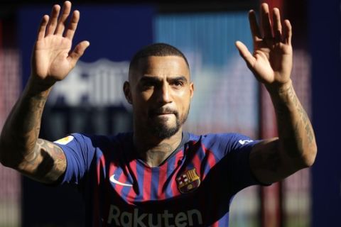 FC Barcelona new signing Kevin-Prince Boateng waves during his presentation at the Camp Nou stadium in Barcelona, Spain, Tuesday, Jan. 22, 2019. Barcelona surprisingly signed Kevin-Prince Boateng on loan from Italian club Sassuolo on Monday until the end of the season. The 31-year-old Boateng has appeared to be past his prime after playing for the likes of AC Milan, Borussia Dortmund, Schalke, and Tottenham. (AP Photo/Emilio Morenatti)