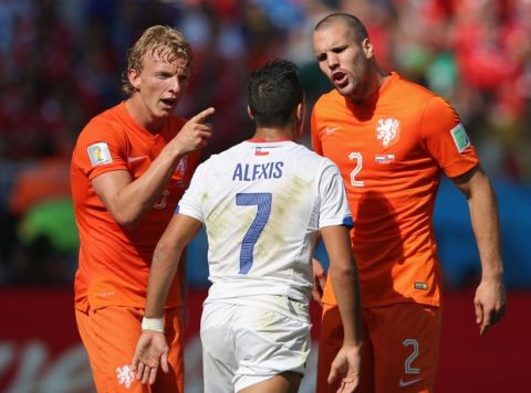 SAO PAULO, BRAZIL - JUNE 23:  Daley Blind and Ron Vlaar of the Netherlands react toward Alexis Sanchez of Chile during the 2014 FIFA World Cup Brazil Group B match between the Netherlands and Chile at Arena de Sao Paulo on June 23, 2014 in Sao Paulo, Brazil.  (Photo by Dean Mouhtaropoulos/Getty Images)