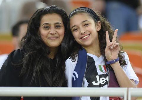 Saudi supporters of Juventus pose for a picture ahead of the Italian Super Cup final soccer match between AC Milan and Juventus at King Abdullah stadium in Jiddah, Saudi Arabia, Wednesday, Jan. 16, 2019. (AP Photo)