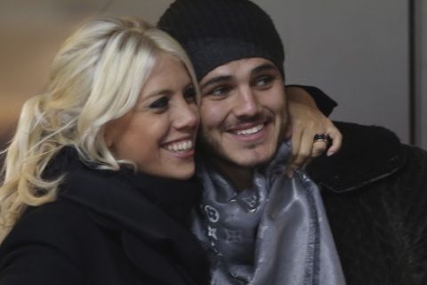 Inter Milan forward Mauro Icardi, of Argentina, poses with Argentine model Wanda Nara as they sit in the stands prior to a Serie A soccer match between Inter Milan and Chievo, at the San Siro stadium in Milan, Italy, Monday, Jan.13, 2014. (AP Photo/Luca Bruno)