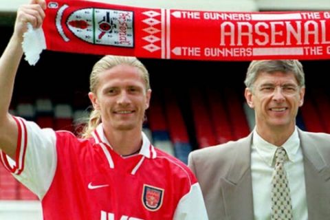 Arsene Wenger manager of English Premier league club Arsenal, centre, is flanked by his club's two new signings, Frenchman Emmanuel Petit, 26, left, and Marc Overmars, 24, from the Netherlands as they are presented to the press on the pitch at Highbury stadium in north London Tuesday June 17, 1997. (AP Photo /Michael Stephens) *UNITED KINGDOM OUT*