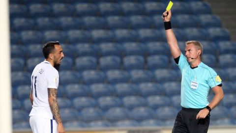 Referee Jakob Kehlet shows a yellow card to Greece's Kostas Mitroglou during the World Cup Group H qualifying soccer match between Gibraltar and Greece outside Faro, southern Portugal, Tuesday, Sept. 6, 2016. (AP Photo/Armando Franca)