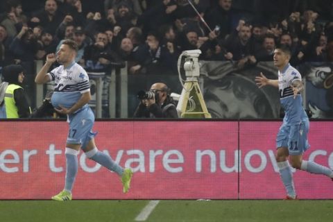 Lazio's Ciro Immobile, left, celebrates with his teammate Joaquin Correa after scoring his side's second goal during a Serie A soccer match between Lazio and Roma at Rome's Olympic stadium, Italy, Saturday, March 2, 2019. (AP Photo/Alessandra Tarantino)