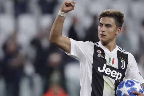 Juventus forward Paulo Dybala holds the ball after scoring a hat trick at the end of the Champions League, group H soccer match between Juventus and Young Boys, at the Allianz stadium in Turin, Italy, Tuesday, Oct. 2, 2018. (AP Photo/Luca Bruno)