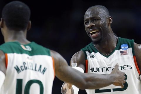 Miami's Tonye Jekiri (23) and Sheldon McClellan (10) react during the second half of a second round game against Wichita State in the NCAA men's college basketball tournament in Providence, R.I., Saturday, March 19, 2016. Miami won 65-57. (AP Photo/Michael Dwyer)