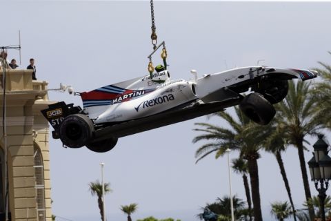 The car of Williams driver Lance Stroll of Canada is lifted after a crash during the second free practice during the Formula One Grand Prix at the Monaco racetrack in Monaco, Thursday, May 25, 2017. The Formula one race will be held on Sunday. (AP Photo/Claude Paris)