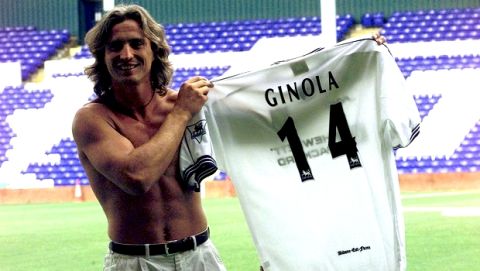 French soccer star David Ginola holds up his new Tottenham Hotspur shirt, with the number he will carry for the London soccer team in the teams ground Tuesday July 15, 1997, after he signed a 2 million pound, four-year contract earlier with the team.(AP Photo/Max Nash)