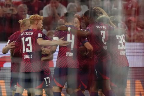 Leipzig's Dani Olmo celebrates with teammates after scoring his sides first goal during the German Super Cup final between FC Bayern Munich and RB Leipzig at the Allianz Arena stadium in Munich, Germany, Saturday, Aug. 12, 2023. (AP Photo/Matthias Schrader)