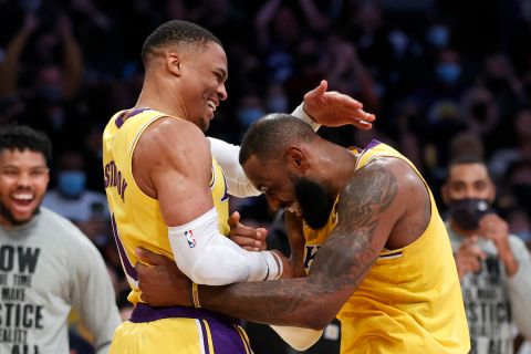 Los Angeles Lakers guard Russell Westbrook, left, is congratulated by forward LeBron James after scoring against the Utah Jazz during the second half of an NBA basketball game in Los Angeles, Monday, Jan. 17, 2022. The Lakers won 101-95. (AP Photo/Ringo H.W. Chiu)