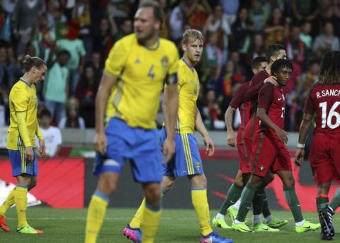 Portugal's Gelson Martins and Cristiano Ronaldo celebrate their side's 2nd goal during the international friendly soccer match between Portugal and Sweden at the dos Barreiros stadium in Funchal, Madeira island, Portugal, Tuesday, March 28 2017. (AP Photo/Armando Franca)