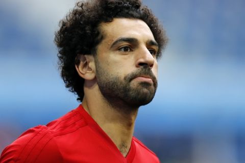 FILE - In this file photo dated Monday, June 18, 2018, Egypt's Mohamed Salah practices during Egypt's official training on the eve of the group A match between Russia and Egypt at the 2018 soccer World Cup,  in St. Petersburg, Russia.  Salah, the Premier Leagues top scorer, greeted adoring crowds who turned up at his door after his Cairo address was leaked on Facebook.  According to media reports, the Liverpool star showed no sign of anger as he received fans, posing for photos and signing autographs shortly after his arrival along with Egypts national team from Russia following a disappointing World Cup showing.  (AP Photo/Efrem Lukatsky, FILE)