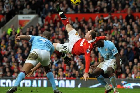 Manchester United's English striker Wayne Rooney (2nd L) scores their second goal during the English Premier League football match between Manchester United and Manchester City at Old Trafford in Manchester, north-west England on February 12, 2011. AFP PHOTO/ANDREW YATESRESTRICTED TO EDITORIAL USE Additional licence required for any commercial/promotional use or use on TV or internet (except identical online version of newspaper) of Premier League/Football League photos. Tel DataCo +44 207 2981656. Do not alter/modify photo (Photo credit should read ANDREW YATES/AFP/Getty Images)