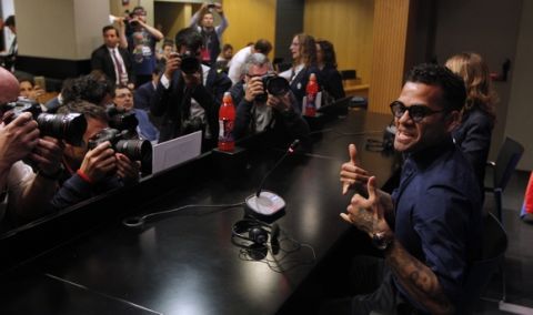 Juventus's Dani Alves gestures during a press conference at the Camp Nou stadium in Barcelona, Spain, Tuesday, April 18, 2017.  FC Barcelona will play against Juventus in a Champions League quarterfinal, second-leg soccer match on Wednesday.(AP Photo/Manu Fernandez)