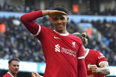 Liverpool's Trent Alexander-Arnold celebrates after scoring his side's opening goal during the English Premier League soccer match between Manchester City and Liverpool at Etihad stadium in Manchester, England, Saturday, Nov. 25, 2023. (AP Photo/Rui Vieira)