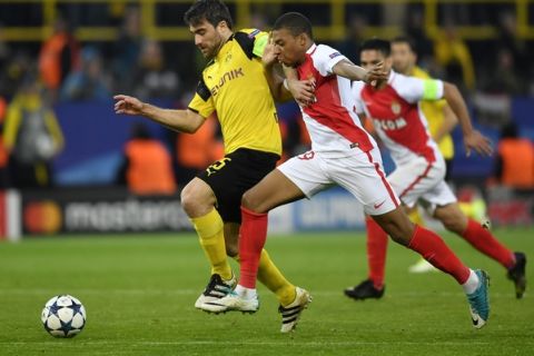 Dortmund's Sokratis Papastathopoulos, left, and Monaco's Kylian Mbappe challenge for the ball during the Champions League quarterfinal first leg soccer match between Borussia Dortmund and AS Monaco in Dortmund, Germany, Wednesday, April 12, 2017. (AP Photo/Martin Meissner)
