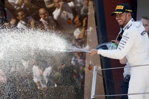 Mercedes driver Lewis Hamilton of Britain sprays champagne on the podium after winning the Spanish Formula One Grand Prix at the Barcelona Catalunya racetrack in Montmelo, Spain, Sunday, May 14, 2017. (AP Photo/Manu Fernandez)