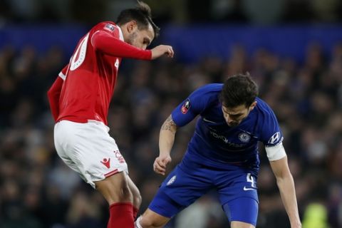 Chelsea's Cesc Fabregas vies for the ball with Nottingham Forest's Joao Carvalho, left, during the English FA Cup third round soccer match between Chelsea and Nottingham Forest at Stamford Bridge in London, Saturday, Jan. 5, 2019. (AP Photo/Alastair Grant)