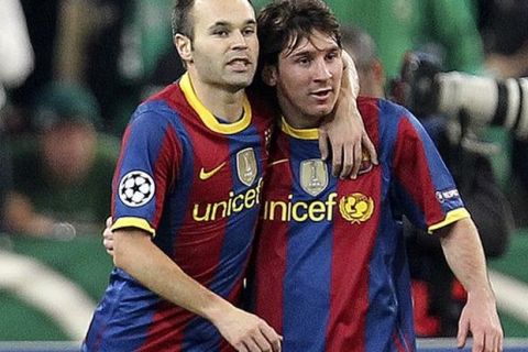 Barcelona's Lionel Messi, right, and Andres Iniesta reacts after the third goal of their team during a Champions League group D soccer match against Panathinaikos at the Olympic stadium of Athens, Wednesday, Nov. 24, 2010. (AP Photo/Thanassis Stavrakis)