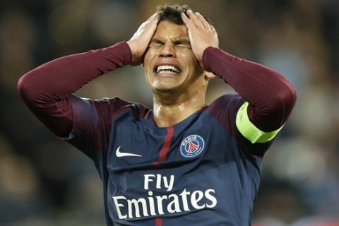 PSG's Thiago Silva reacts after missing a chance to score during a Champions League Group B soccer match between Paris St. Germain and Celtic at the Parc des Princes stadium in Paris, France, Wednesday, Nov. 22, 2017. Banner in the middle reads : Never alone. (AP Photo/Christophe Ena)