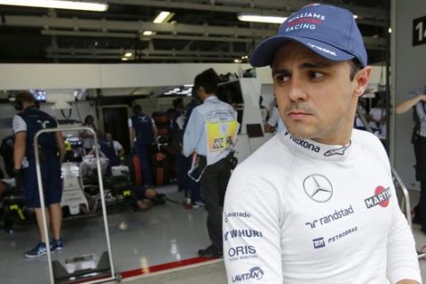 Williams driver Felipe Massa of Brazil stands in front of his garage during the second practice session for the Japanese Formula One Grand Prix at the Suzuka Circuit in Suzuka, central Japan, Friday, Sept. 25, 2015. (AP Photo/Shizuo Kambayashi)