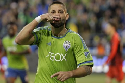 FILE - In this April 26, 2015 file photo, Seattle Sounders' Clint Dempsey makes a face as he celebrates his goal against the Portland Timbers during the second half of an MLS soccer match in Seattle. On Wednesday, Aug. 29, 2018, Dempsey announced his retirement, stepping away at age 35 after 15 years of playing professionally. (AP Photo/Ted S. Warren, File)