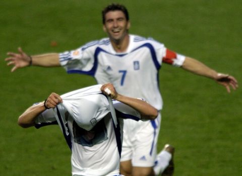 epa000226632 Greek striker Angelos Charisteas is celebrated by captain Theodoros Zagorakis (rear) after scoring the 1-0 lead during the Euro 2004 final between Portugal and Greece at Luz stadium in Lisbon on Sunday, 04 July 2004.  EPA/OLIVER BERG NO MOBILE PHONE APPLICATIONS