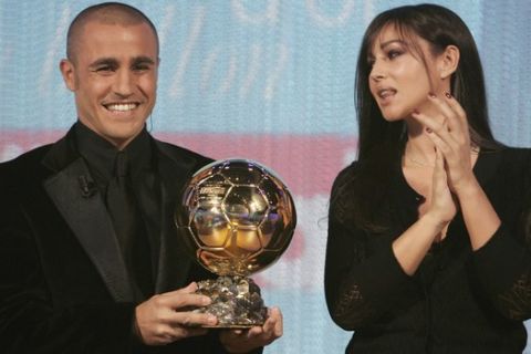 Italian actress Monica Bellucci, right, applauds after she handed Real Madrid's defender Fabio Cannavaro, the captain of Italy's soccer World Cup champion team, the 2006 Golden Ball award during a live broadcast on French television channel Canal Plus, Monday, Nov. 27, 2006 in Paris. Cannavaro won the 2006 Golden Ball trophy, the French football magazine's prestigious award as Europe's top player. (AP Photo/Francois Mori)