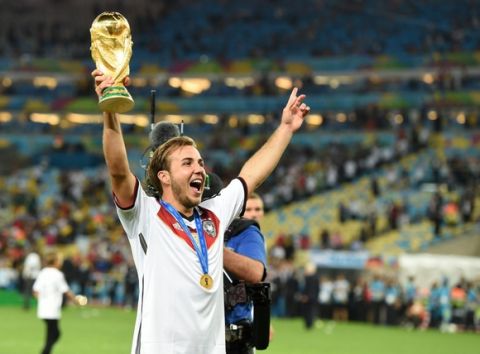 July 13, 2014; Rio de Janeiro, BRAZIL; Germany midfielder Mario Gotze (19) celebrates with the world cup trophy after the championship match of the 2014 World Cup against the Argentina at Maracana Stadium. Germany won 1-0.  Mandatory Credit: Tim Groothuis/Witters Sport via USA TODAY Sports