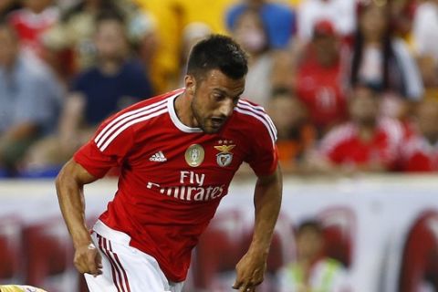 SL Benfica midfielder Andreas Samaris (7) moves the ball past New York Red Bulls midfielder Sal Zizzo (15) during the first half of a soccer match in the International Champions Cup in Harrison N.J., Sunday, July 26, 2015. The Red Bulls defeated Benfica 2-1. (AP Photo/Rich Schultz)
