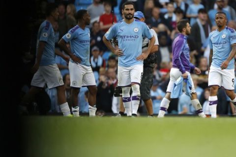 Manchester City players react at the end of the the English Premier League soccer match between Manchester City and Tottenham Hotspur at Etihad stadium in Manchester, England, Saturday, Aug. 17, 2019. (AP Photo/Rui Vieira)