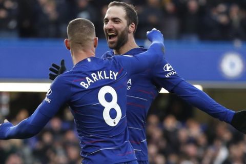 Chelsea's Gonzalo Higuain celebrates with Chelsea's Ross Barkley after scoring his side's fourth goal during the English Premier League soccer match between Chelsea and Huddersfield Town at Stamford Bridge stadium in London, Britain, Saturday, Feb. 2, 2019. (AP Photo/ Alastair Grant)
