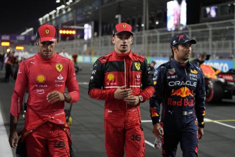From the left, second placed Ferrari driver Charles Leclerc of Monaco, first placed Red Bull driver Sergio Perez of Mexico and third placed Ferrari driver Carlos Sainz of Spain walk after the qualifying session for the Formula One Grand Prix it in Jiddah, Saudi Arabia, Saturday, March 26, 2022. (AP Photo/Hassan Ammar)