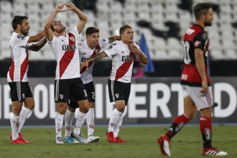 Camilo Mayada of Argentina's River Plate, second from left, celebrates with teammates after scoring against Brazil's Flamengo during a Copa Libertadores soccer match in Rio de Janeiro, Brazil, Wednesday, Feb. 28, 2018. (AP Photo/Leo Correa)