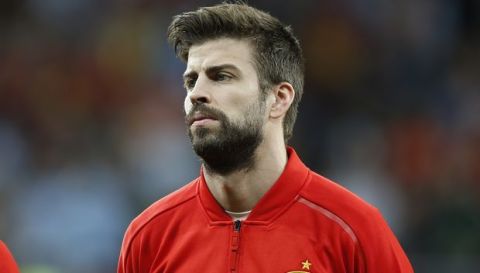 Spain's Gerard Pique listens to the national anthem before the international friendly soccer match between Spain and Argentina at the Wanda Metropolitano stadium in Madrid, Spain, Tuesday March 27, 2018. (AP Photo/Paul White)