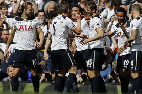 Tottenham teammates celebrate after scoring during the English Premier League soccer match between Tottenham Hotspur and Bournemouth at White Hart Lane stadium in London, Saturday, April 15, 2017.(AP Photo/Frank Augstein)