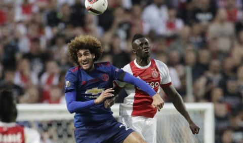 Manchester's Marouane Fellaini, left, and Ajax's Davinson Sanchez go for a header during the soccer Europa League final between Ajax Amsterdam and Manchester United at the Friends Arena in Stockholm, Sweden, Wednesday, May 24, 2017. (AP Photo/Michael Sohn)