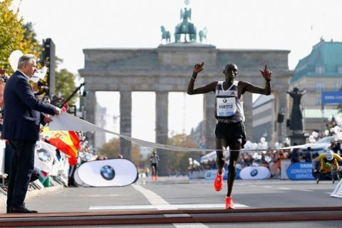 BERLIN, GERMANY - SEPTEMBER 28:  Dennis Kimetto of Kenya crosses the finish line in new world record time during the 41th BMW Berlin Marathon on September 28, 2014 in Berlin, Germany.  (Photo by Boris Streubel/Bongarts/Getty Images)