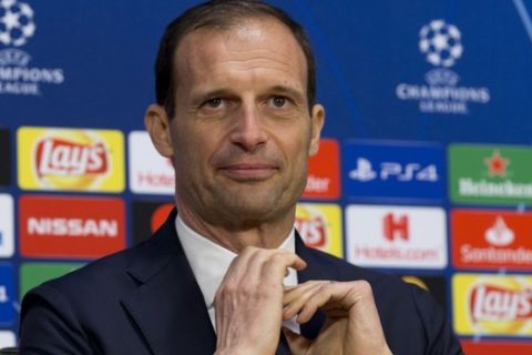 Juventus coach Massimiliano Allegri adjusts his tie at the start of a press conference at the Johan Cruyff ArenA in Amsterdam, Netherlands, Tuesday, April 9, 2019. (AP Photo/Peter Dejong)