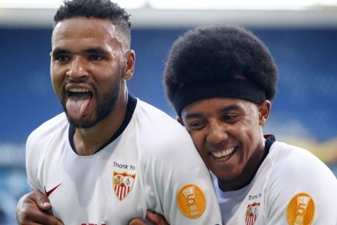 Sevilla's Youssef En-Nesyri celebrates with Sevilla's Jules Kounde after scoring his side's 2nd goal during the Europa League, round of 16 soccer match between Roma and Sevilla, at the Schauinsland-Reisen-Arena in Duisburg, Germany, Thursday, Aug. 6, 2020. (Wolfgang Rattay/Pool Photo via AP)