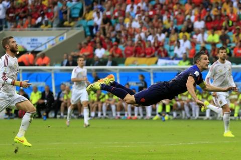 Netherlands' Robin van Persie flies through the air after scoring a goal during the group B World Cup soccer match between Spain and the Netherlands at the Arena Ponte Nova in Salvador, Brazil, Friday, June 13, 2014.(AP Photo/Bernat Armangue)