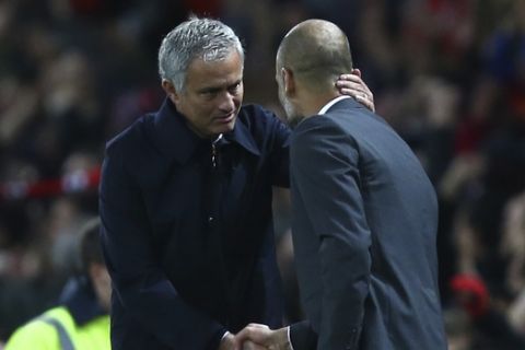Manchester United's manager Jose Mourinho, left, and Manchester City's manager Pep Guardiola shake hands after the English League Cup soccer match between Manchester United and Manchester City at Old Trafford stadium in Manchester, England, Wednesday, Oct. 26, 2016. (AP Photo/Dave Thompson)
