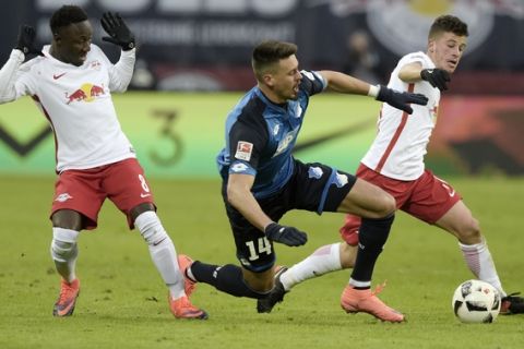 Hoffenheim's Sandro Wagner, center, challenges for the ball with Leipzig's Diego Demme, right, besides Leipzig's Naby Keita, left, during the German first division Bundesliga soccer match between RB Leipzig and TSG 1899 Hoffenheim in Leipzig, Germany, Saturday, Jan. 28, 2017. (AP Photo/Jens Meyer)