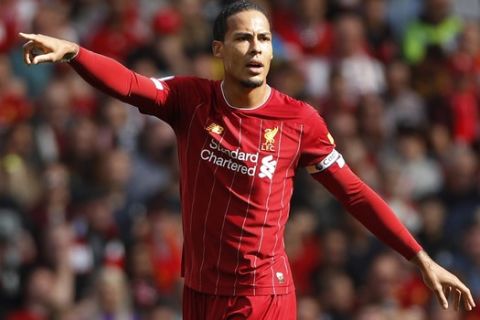 Liverpool's Virgil van Dijk gestures during the English Premier League soccer match between Liverpool and Newcastle at Anfield stadium in Liverpool, England, Saturday, Sept. 14, 2019. (AP Photo/Rui Vieira)