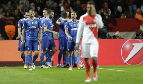 Juventus' Gonzalo Higuain, third from right, celebrates with his teammates after scoring during the Champions League semifinal first leg soccer match between Monaco and Juventus at the Louis II stadium in Monaco, Wednesday, May 3, 2017. (AP Photo/Claude Paris)