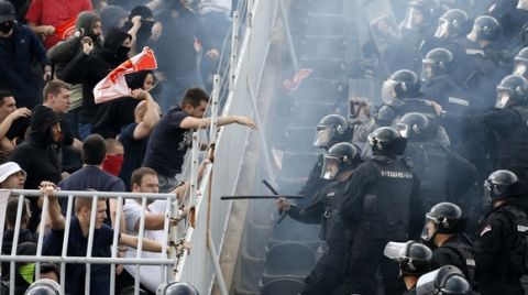 Serbian riot police officers clash with Red Star soccer fans during Serbian National Cup final soccer match between Partizan and Red Star, in Belgrade, Serbia, Saturday, May 27, 2017. (AP Photo/Darko Vojinovic)