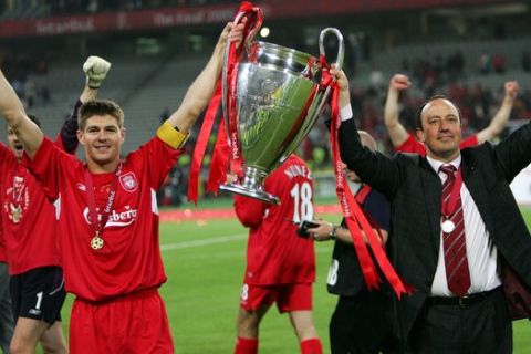 Liverpool's captain Steven Gerrard, left, and coach Rafael Benitez hold the trophy aloft after the UEFA Champions League Final between AC Milan and Liverpool at the Ataturk Olympic Stadium in Turkey, Istanbul Wednesday May 25, 2005. Liverpool won 3-2 on penalties after the match finished 3-3 after extra time.  (AP Photo/Thomas Kienzle)